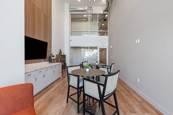 A modern kitchen with a dining table and chairs.
